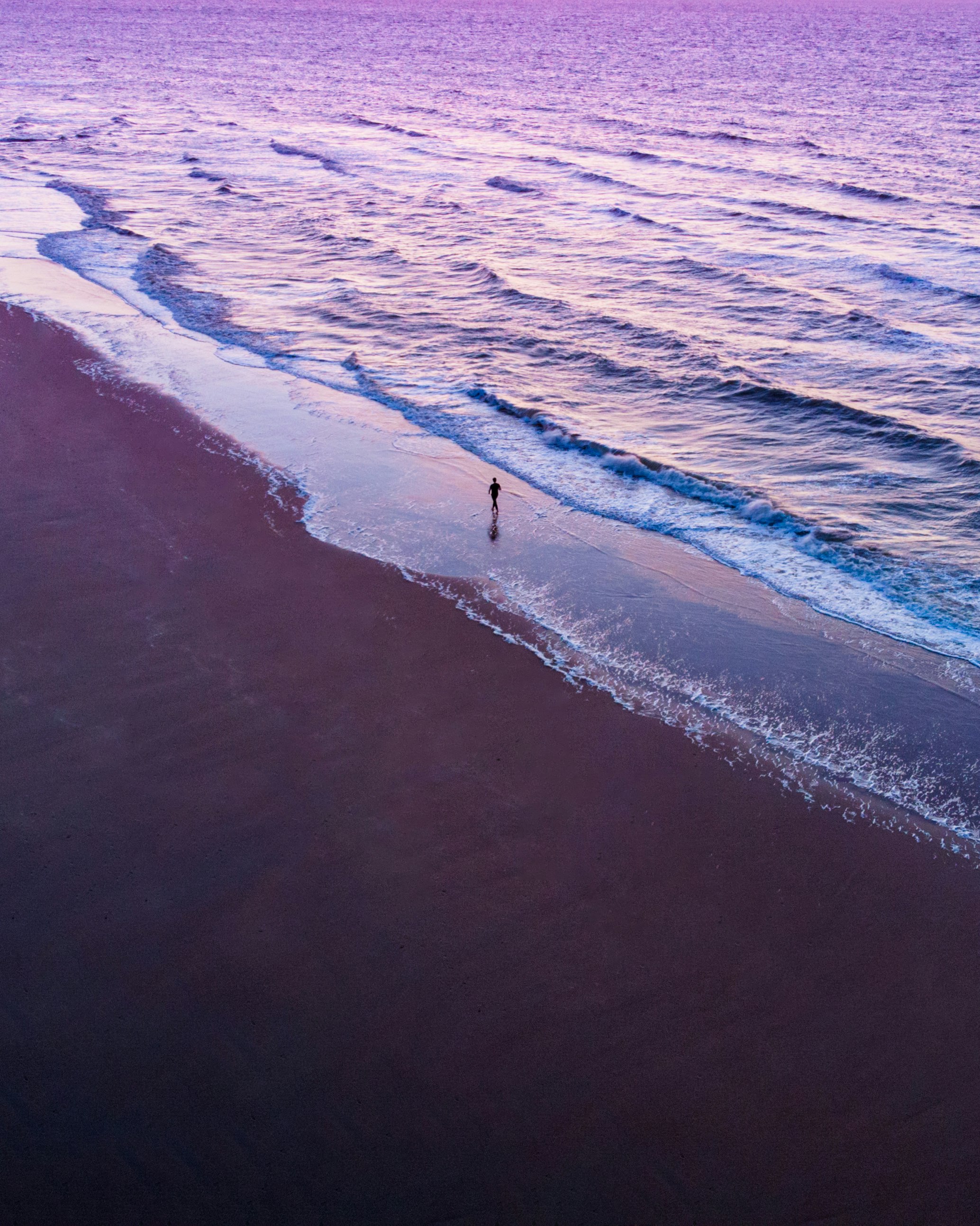 person walking on beach during daytime